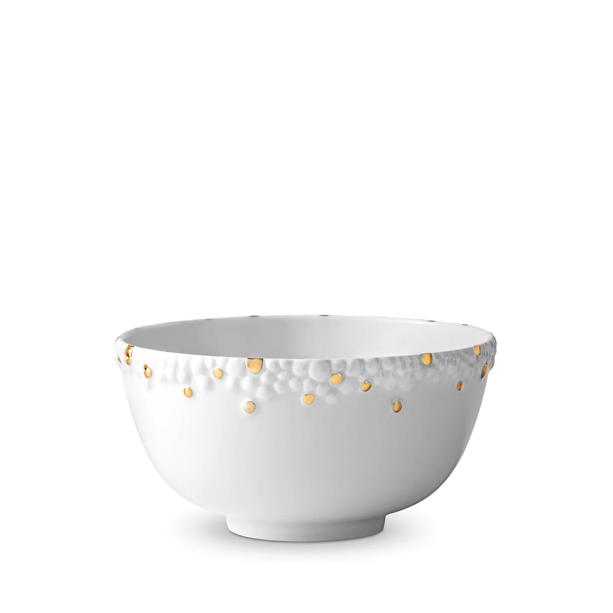 A fine porcelain bowl from L'Objet's Haas Mojave Dinnerware Gold collection, featuring a textured rim with scattered gold dots along the top edge on a plain white background.