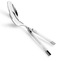 The Capdeco Conty Salad Serving Set White features 18/10 stainless steel salad servers with white handles, elegantly crossed over each other on a white background.