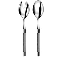 The Capdeco1 Conty Salad Serving Set Grey includes two French-made 18/10 stainless steel servers with shiny heads and marble-patterned handles: one spoon and one forked, slotted piece for effortless salad serving.