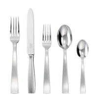 The Sambonet Gio Ponti Flatware 5 Piece Setting in stainless steel includes a dinner fork, knife, salad fork, soup spoon, and teaspoon, displayed in a row on a white background.