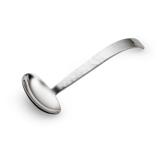 The Mary Jurek Valencia Gravy Ladle is handmade from stainless steel and features a deep, round bowl with a long, gently curved handle. Photographed on a white background.