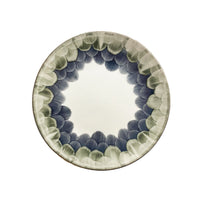 The Marie Daâge Cercle d'Ecailles Dessert Plate features a white center and a rim decorated with hand-painted green and blue brushstroke patterns—a refined Limoges porcelain piece by Marie Daâge.