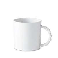 The L’Objet Haas Mojave White Dinnerware mug is made of fine porcelain and features a distinctive, textured beaded handle inspired by the playful artistry of the Haas Brothers.