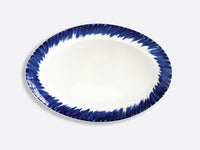 The Bernardaud In Bloom Dinnerware plate is round and white porcelain, with a dark blue brushstroke-style border on the rim, shown against a light gray background.