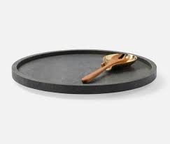 The Calvin Faux Shagreen Lazy Susan Grey by Blue Pheasant, a round grey serving tray with a raised edge, comes with a gold-toned spoon and fork with wooden handles, displayed on a plain white background.
