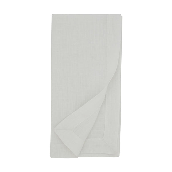 A neatly folded Simple Linen Napkin from Saro Trading is displayed on a white background, with one corner slightly turned up to reveal the hemmed edge—an elegant example from their White Set of 4 classic linen napkins.
