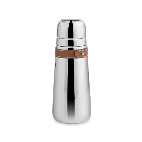 The Nambe Tahoe Cocktail Shaker features shiny stainless steel with a rounded cap and a brown leather strap around the neck, shown against a plain white background.