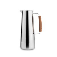 Tall, polished stainless steel Nambe Tahoe Pitcher with a brown leather-wrapped handle.
