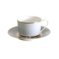 The Recamier MAK Grey & Platinum teacup and saucer by Royal Limoges/Bia Cordon Bleu features elegant gray bands with platinum accents, exemplifying contemporary dinnerware style against a white background.