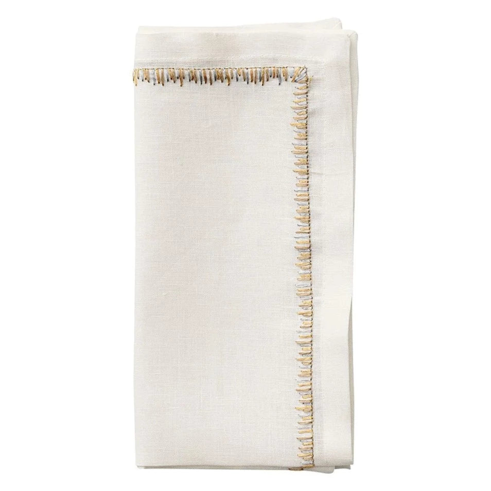The Kim Seybert Filament Napkin Gold & Silver Set of 4 features elegant white embroidered linen with decorative metallic stitching—ideal for enhancing your festive table setting.