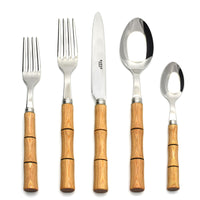 The Sabre Bamboo Flatware 5 Piece Setting features 18/10 stainless steel heads and bamboo-style handles, elegantly arranged on a white background to highlight the refined design.