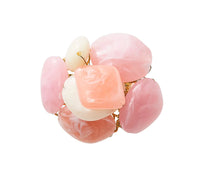 The Kim Seybert Sea Stone Napkin Ring Blush Set of 4 features large blush pink and white resin stones set close together on a gold ring, shown against a white background.