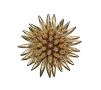 The Stellar Napkin Ring Gold Set of 4 by Kim Seybert features a symmetrical, gold-toned, three-dimensional flower design with layered, elongated petals radiating from the center, evoking elegance and beautifully showcased against a white background.