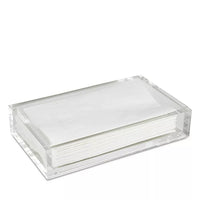 A stack of white paper napkins neatly arranged in the Caspari Acrylic Guest Towel Holder on a white background.