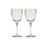 The Zafferano Perle Wine Goblet Set of 2 features clear, dotted textured goblets standing side by side on a white background. Made in Italy.