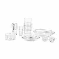 A set of clear ribbed glass tableware—plates, bowls, cups—and the Tom Dixon Press Vertical Tealight are arranged together on a white background.