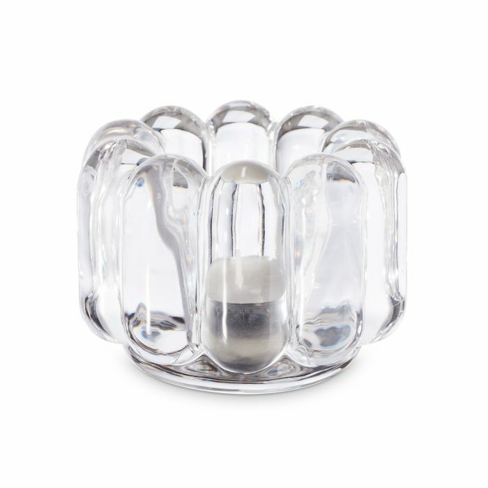 The Press Vertical Tealight by Tom Dixon is a clear, rounded glass candle holder with a wavy, bubbled design that holds a small white tealight in the center.