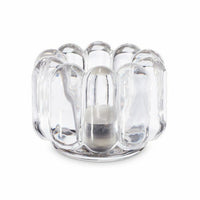 The Press Vertical Tealight by Tom Dixon is a clear, rounded glass candle holder with a wavy, bubbled design that holds a small white tealight in the center.