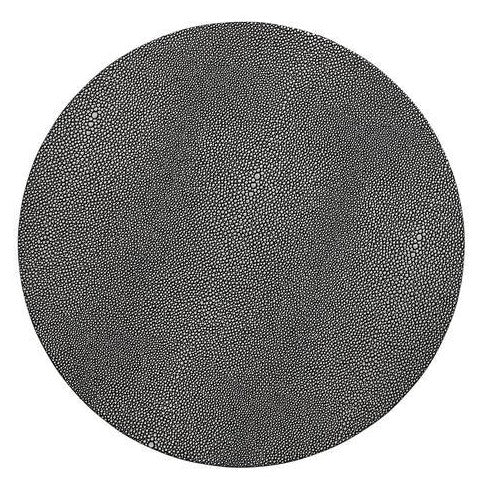 A large black circle densely patterned with small, irregular black dots on white, mirroring the textured elegance of the Kim Seybert Pebble Placemats Set of 4.