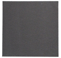 A close-up of the Bodrum Skate Placemat Round Charcoal Set of 4 shows a dark gray, textured surface reminiscent of fine-grain sandpaper or leather, filling the entire frame and reflecting its high-quality vinyl design.