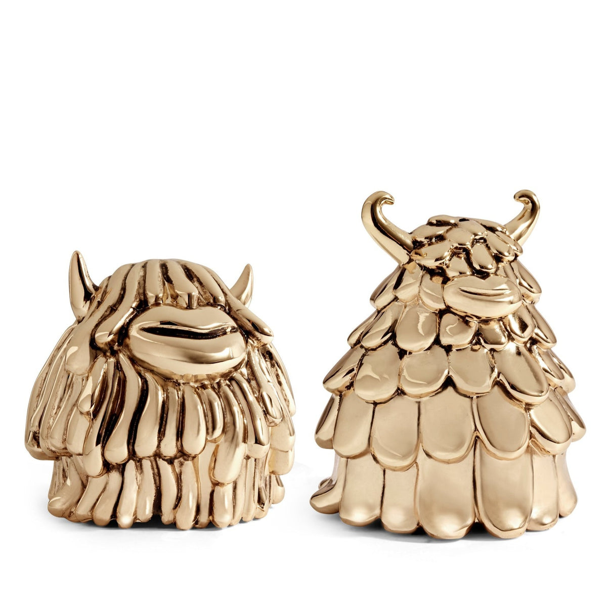 Two shiny gold figurines, Niki & Simon Salt & Pepper by Haas Brothers for L'Objet, feature whimsical monster-like forms with textured bodies and small horns. The spice shakers are displayed side by side on a white background.