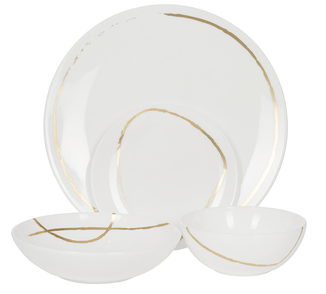 The Sketch Chalk Dinnerware by Royal Crown Derby features three white fine bone china bowls and plates with simple, irregular gold lines, elegantly arranged on a white background.
