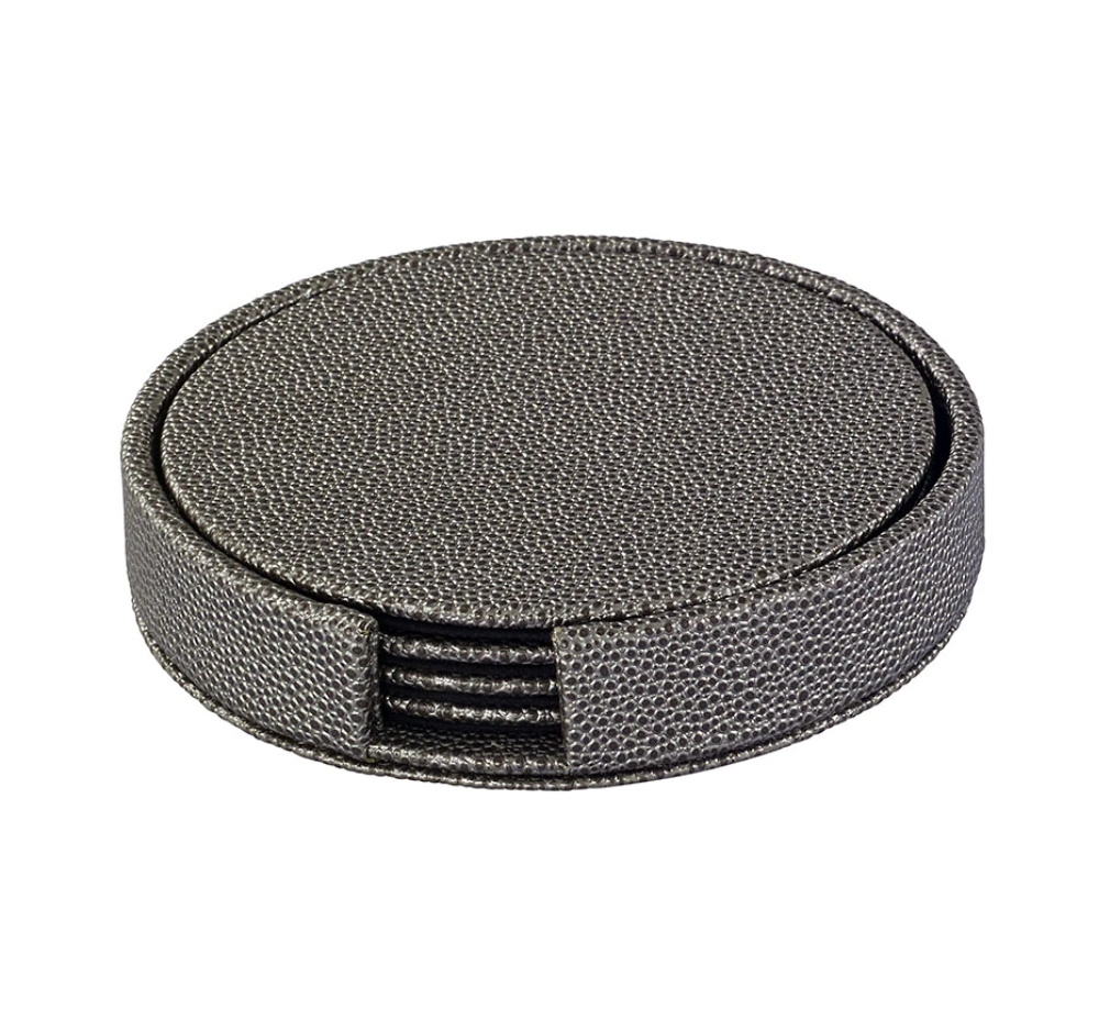 The Bodrum Skate Coaster Set of 4 includes round, textured dark gray phthalate-free vinyl coasters with a holder featuring a front opening that reveals the matching set inside.