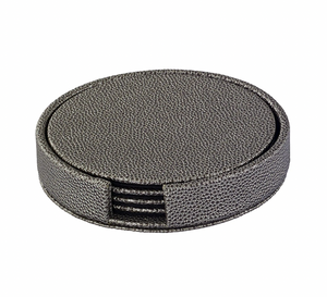 The Bodrum Skate Coaster Set of 4 includes round, textured dark gray phthalate-free vinyl coasters with a holder featuring a front opening that reveals the matching set inside.