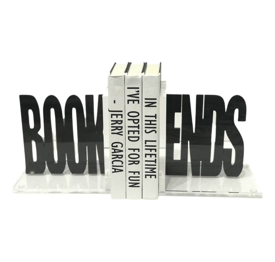 Eye Candy’s Book Ends Charcoal Acrylic spell out "BOOKENDS" in black acrylic, holding three white books with vertical black text: IN THIS LIFETIME I’VE OPTED FOR FUN - JERRY GARCIA. A playful touch for study decor.