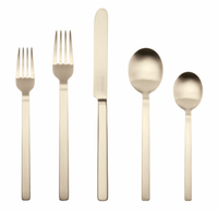 The Stile 5 Piece Setting - Champagne by Mepra features two forks, a knife, a large spoon, and a small spoon with squared handles in a modern minimalist design and luxurious champagne finish, displayed side by side on a white background.