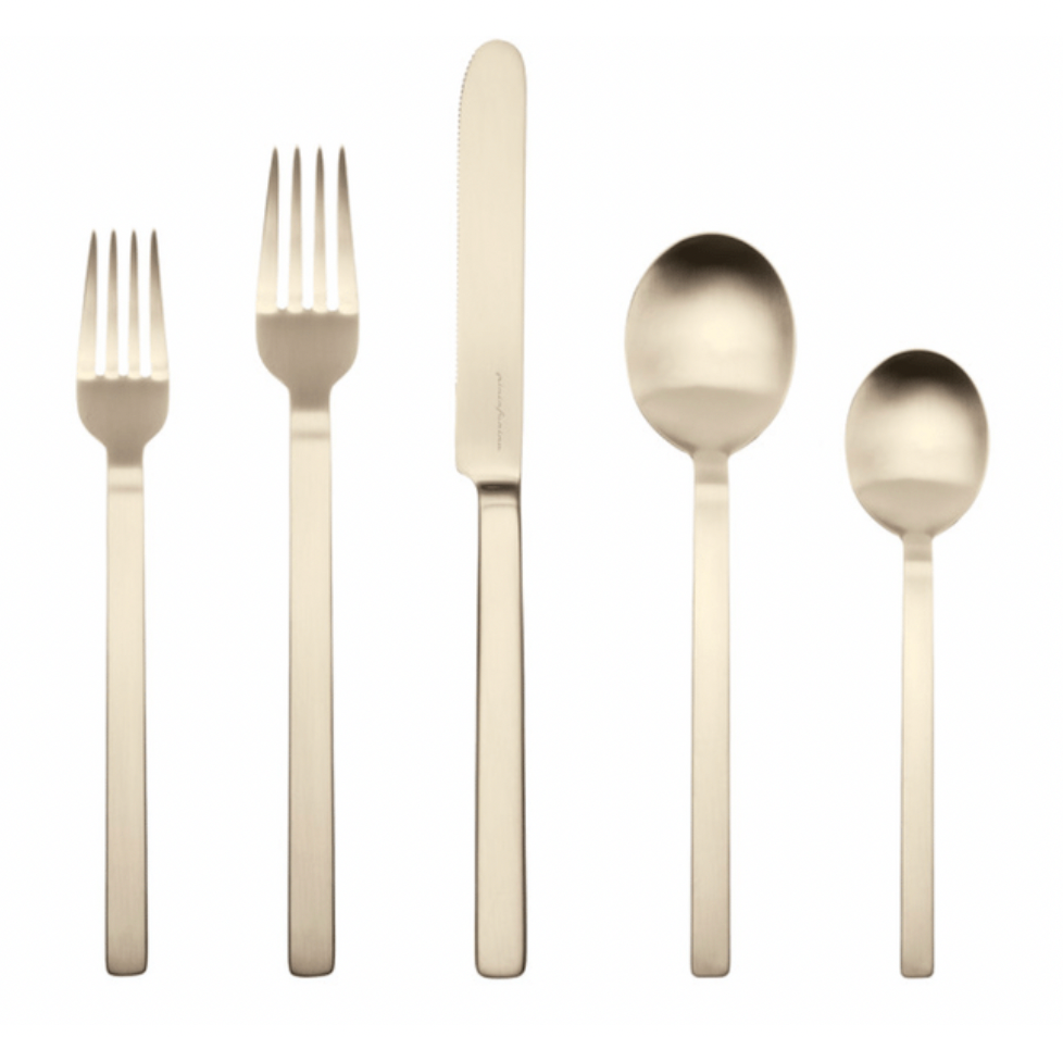 The Mepra Stile 5 Piece Setting - Champagne features two forks, a knife, a tablespoon, and a teaspoon with straight, modern handles and an elegant champagne finish.