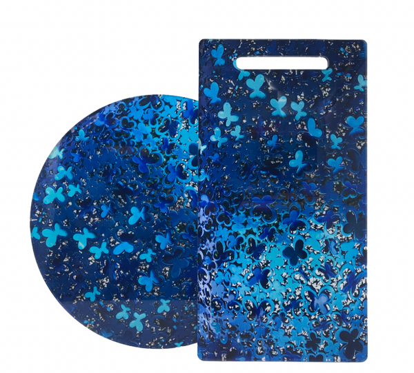Two blue pieces from Eye Candy: the Blue Butterflies Lazy Susan and a rectangular acrylic serving board with butterfly and clover shapes—ideal additions to your Blue Butterfly serving pieces collection.