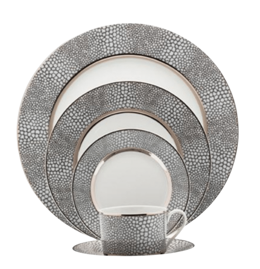 The Makassar Gray & Platinum Dinnerware by Royal Limoges/Bia Cordon Bleu includes five stacked plates and a cup with matching saucer, all handmade in France with a gray and white pebble pattern and silver edges in fine Limoges porcelain.