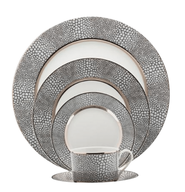 The Makassar Gray & Platinum Dinnerware by Royal Limoges/Bia Cordon Bleu includes five stacked plates and a cup with matching saucer, all handmade in France with a gray and white pebble pattern and silver edges in fine Limoges porcelain.