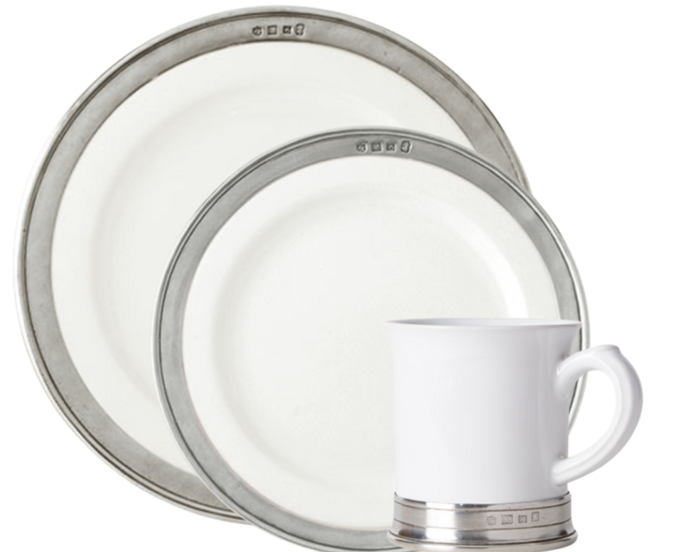Two MATCH Convivio plates in different sizes and a matching handled mug, each adorned with a pewter rim, are elegantly displayed against a plain background.
