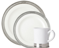 Two MATCH Convivio plates in different sizes and a matching handled mug, each adorned with a pewter rim, are elegantly displayed against a plain background.
