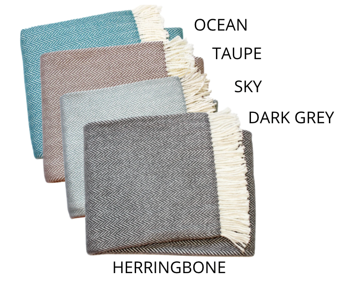Four stacked A Soft Idea Personalized Throw Blankets with fringe are labeled by color from top to bottom: ocean (blue), taupe (beige), sky (light grey), and dark grey. Add a custom or monogrammed touch for a unique throw. "HERRINGBONE" shown below.