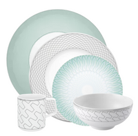 The Trasso Dinnerware set by Vista Alegre includes five pieces: a mint green dinner plate, two geometric platinum-accented white plates, a patterned bowl, and a matching mug.