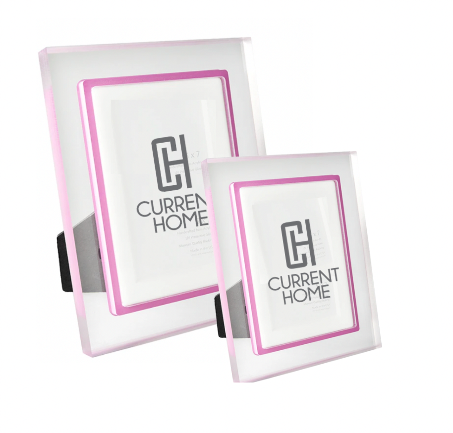 The Prisma Lip Frame - Fuschia by Bella Moulding includes two clear acrylic frames with pink borders in different sizes, each with a black stand for display and a branded insert.