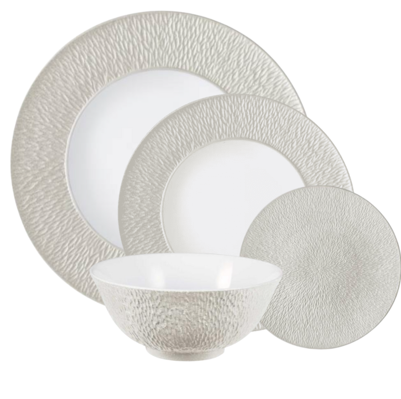 The Raynaud Mineral Irise Dinnerware Pearl Grey set features four textured porcelain pieces—dinner plate, salad plate, bread plate, and bowl—elegantly overlapped on a white background.