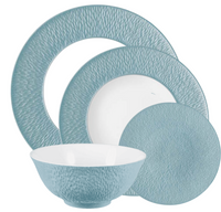 The Raynaud Mineral Irise Dinnerware Sky Blue set features four Limoges porcelain pieces—a large plate, medium plate, small plate, and a bowl with a blue exterior and white interior.