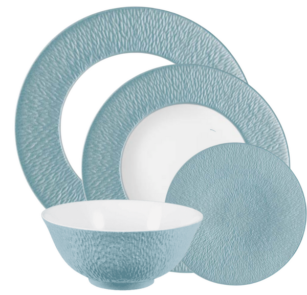 The Raynaud Mineral Irise Dinnerware Sky Blue set features four Limoges porcelain pieces—a large plate, medium plate, small plate, and a bowl with a blue exterior and white interior.