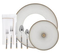 A table set with Raynaud's Oskar Dinnerware: one large and one small patterned porcelain plate, a stitched cloth napkin, plus silver cutlery—knife, fork, spoon, and dessert spoon—all with striped handles and gold accents.