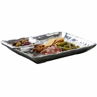 The Linda Chip & Dip Set by Beatriz Ball is a rectangular silver serving piece with divided sections—ideal for elegantly presenting olives, almonds, cured meat, cheese slices, and pickles at any gathering.