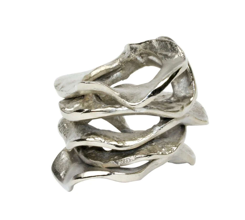 The Kim Seybert Flux Napkin Ring Silver Set of 4 features organically shaped, wave-like rings that add an elegant touch to your table decor, shown here against a white background.