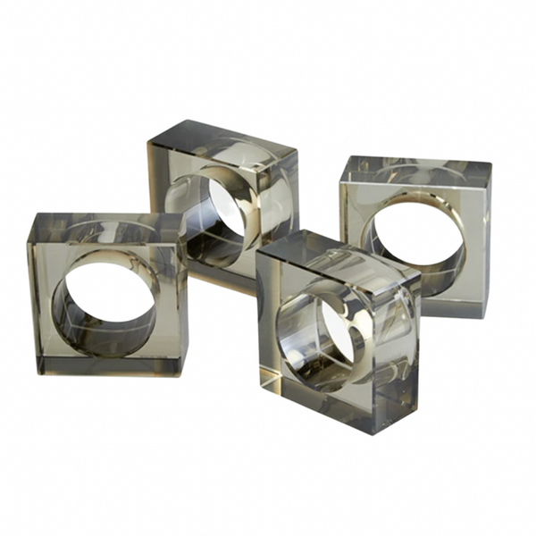 The Tizo Crystal Cube Napkin Ring Smoke Set of 4 features square-shaped, transparent napkin rings with circular openings, arranged on a plain white background.