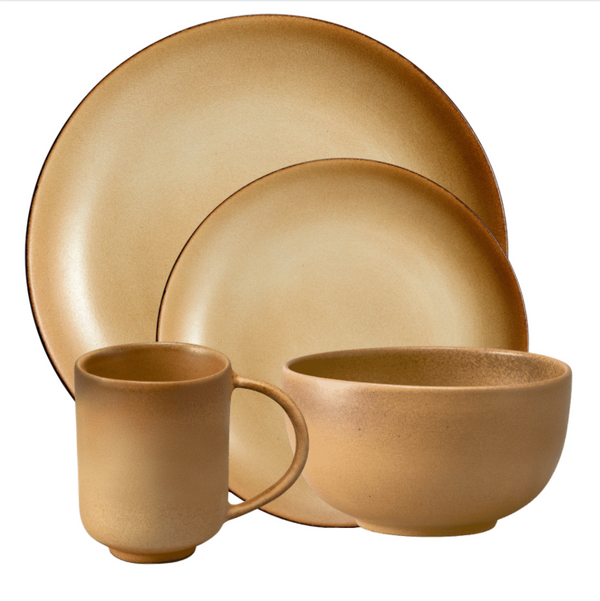The Terra Leather Dinnerware by L'Objet features hand-crafted pieces in warm beige with a matte finish and subtly darker edges, including a large plate, small plate, bowl, and mug for an artisanal touch.