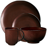 The L'Objet Terra Wine Dinnerware set features handcrafted stoneware in deep brown, including a dinner plate, salad plate, bowl, and mug. All pieces are dishwasher safe and shown against a white background.