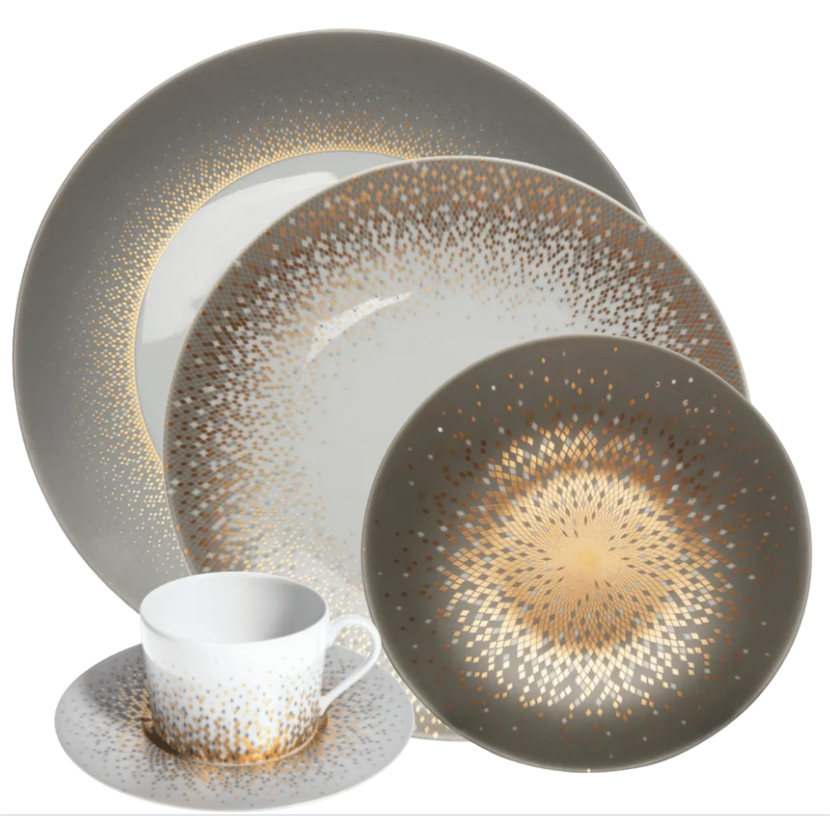 The Haviland Souffle D'or Dinnerware set features fine Limoges porcelain plates, cup, and saucer with a gray base and gold starburst dots radiating from the center.