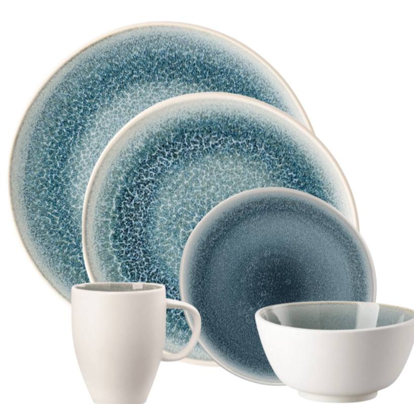 The Rosenthal Junto Aquamarine Dinnerware set includes two blue gradient plates, a blue bowl with a white rim, and a white mug with handle. All pieces feature reactive glaze and are dishwasher and microwave safe.